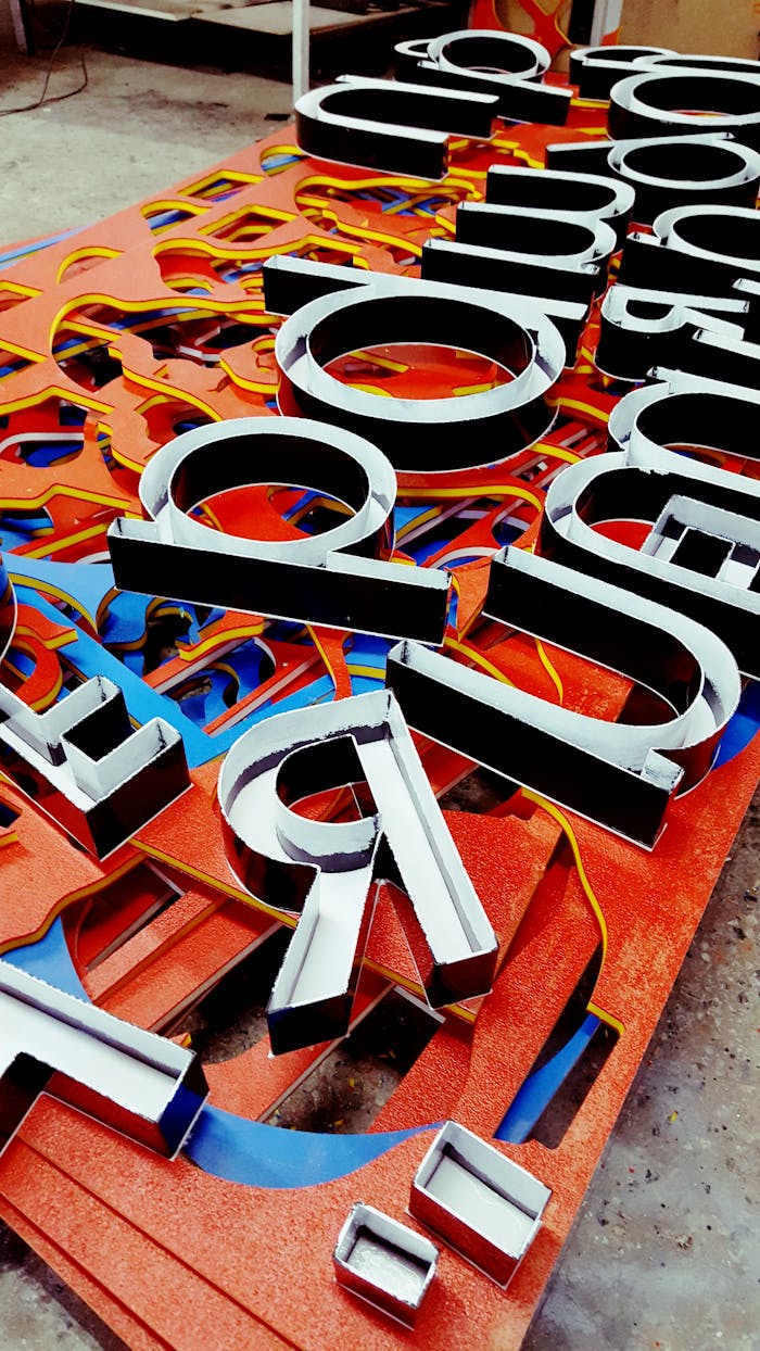 services-05 Vibrant neon letters arranged artistically, showcasing a unique signage design.