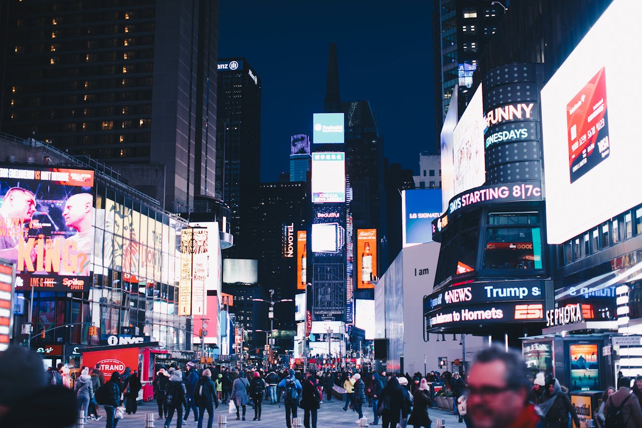 why-choose-us Bustling night scene in Times Square, New York City, illuminated with vibrant advertisements.